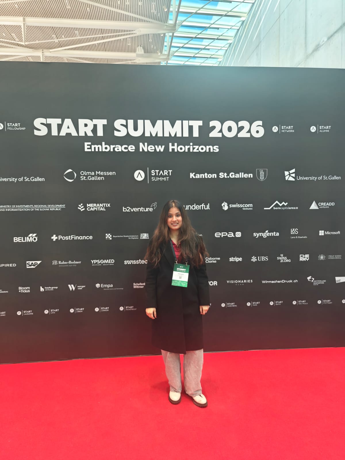 Manvi standing on a red carpet in front of the START Summit 2026 backdrop